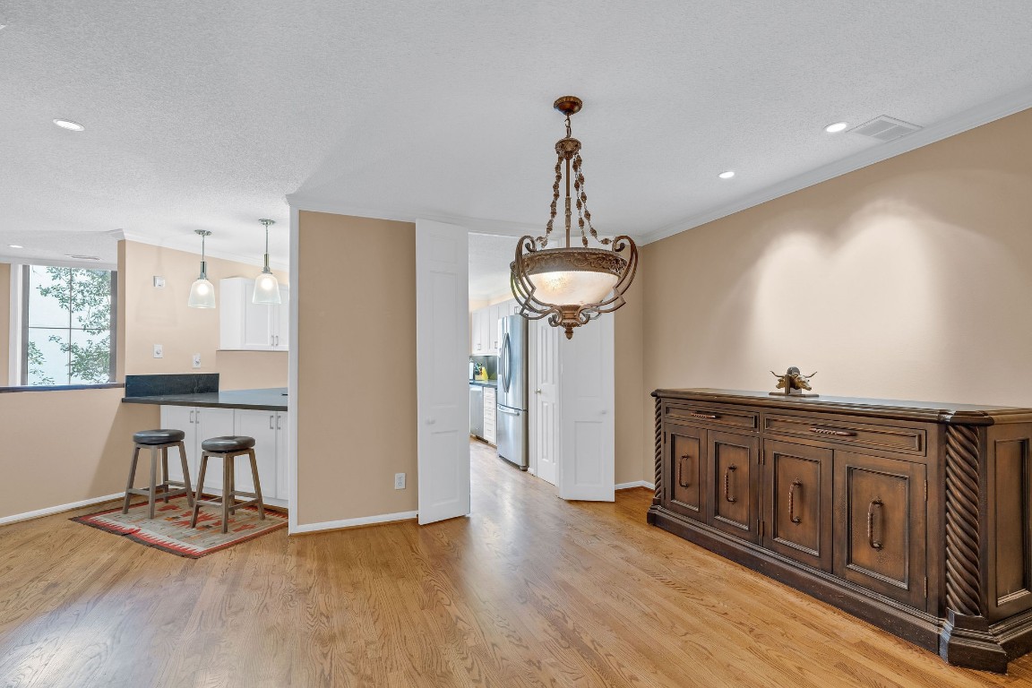 5084 Augusta Street Houston, TX 77007 - Photo 18 of 43 a view of a kitchen with a sink wooden floor and chair