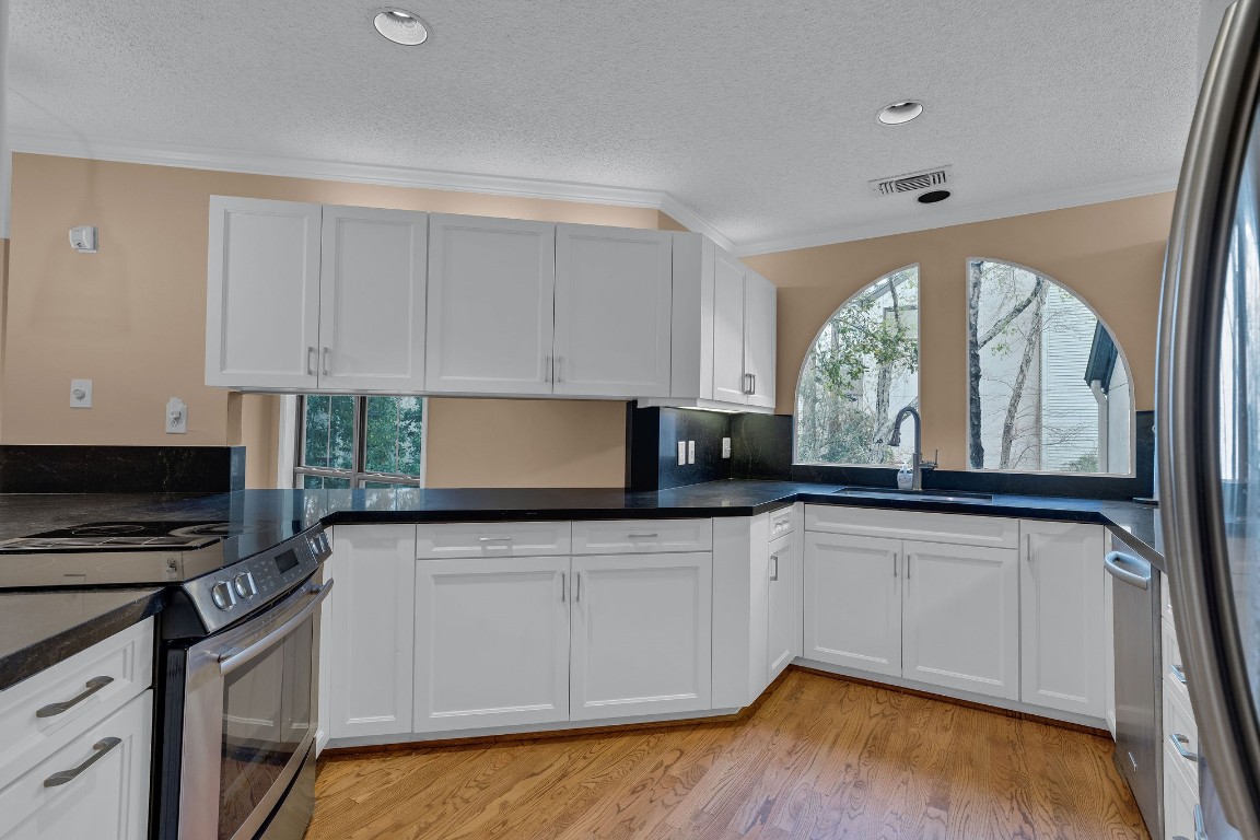5084 Augusta Street Houston, TX 77007 - Photo 20 of 43 a kitchen with granite countertop a stove a sink and a granite counter tops