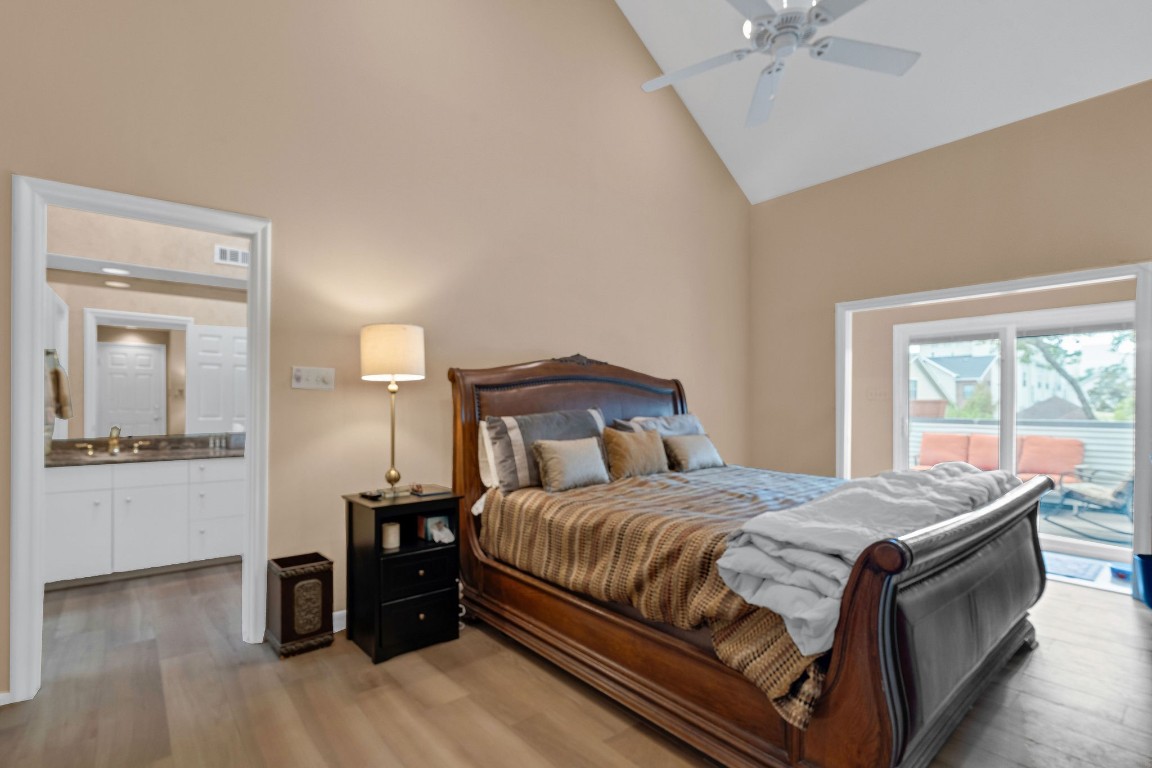 5084 Augusta Street Houston, TX 77007 - Photo 35 of 43 a bedroom with a bed and wooden floor