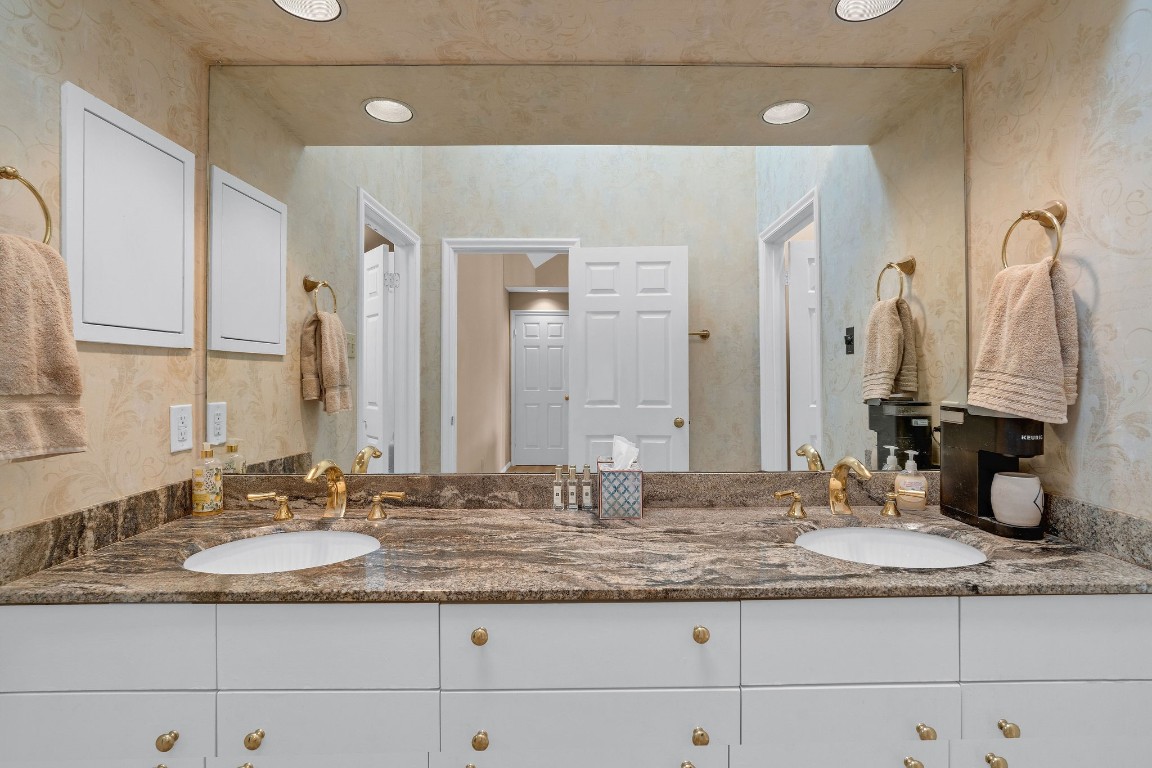 5084 Augusta Street Houston, TX 77007 - Photo 37 of 43 a bathroom with a granite countertop sink and a mirror