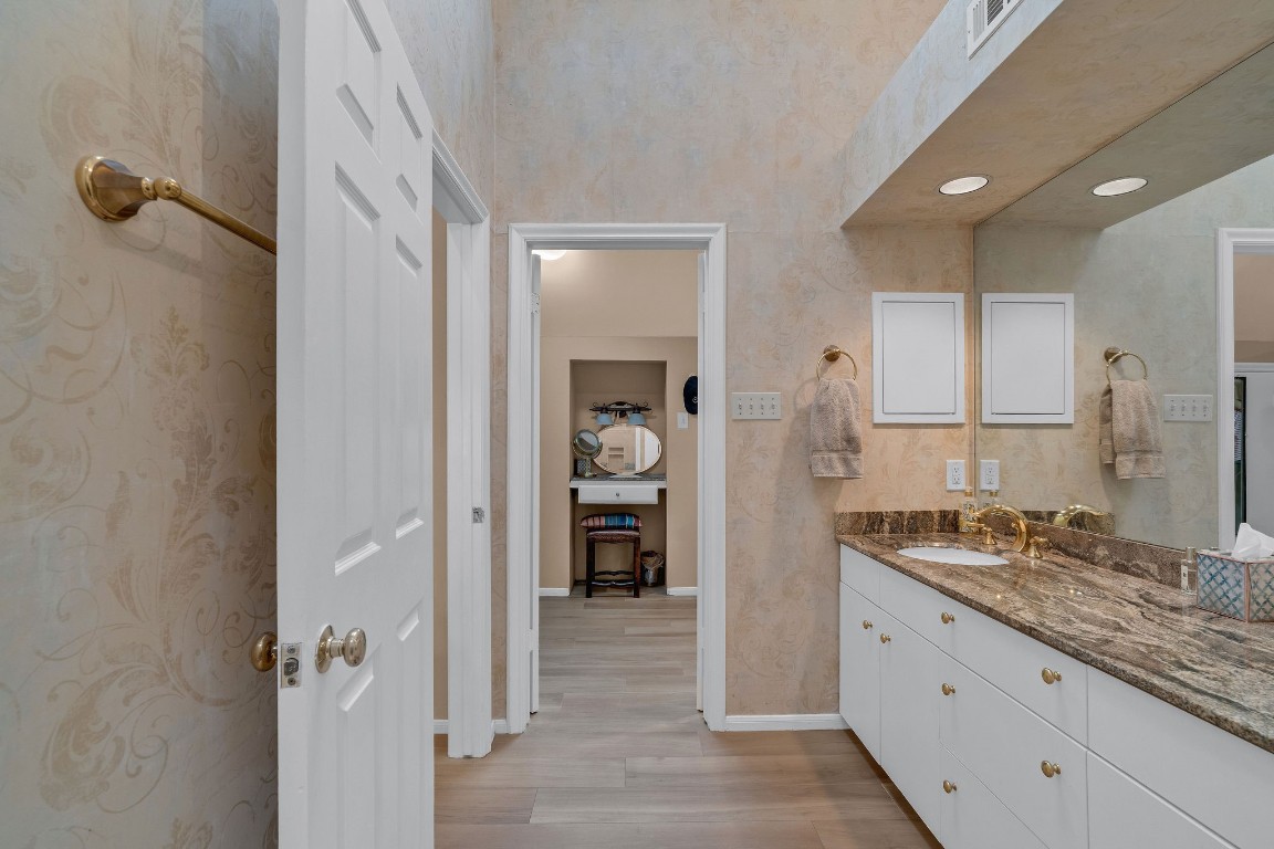 5084 Augusta Street Houston, TX 77007 - Photo 39 of 43 a bathroom with a granite countertop sink and a mirror