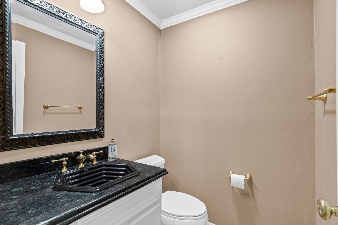5084 Augusta Street Houston, TX 77007 - Photo 9 of 43 a bathroom with a granite countertop sink toilet and mirror