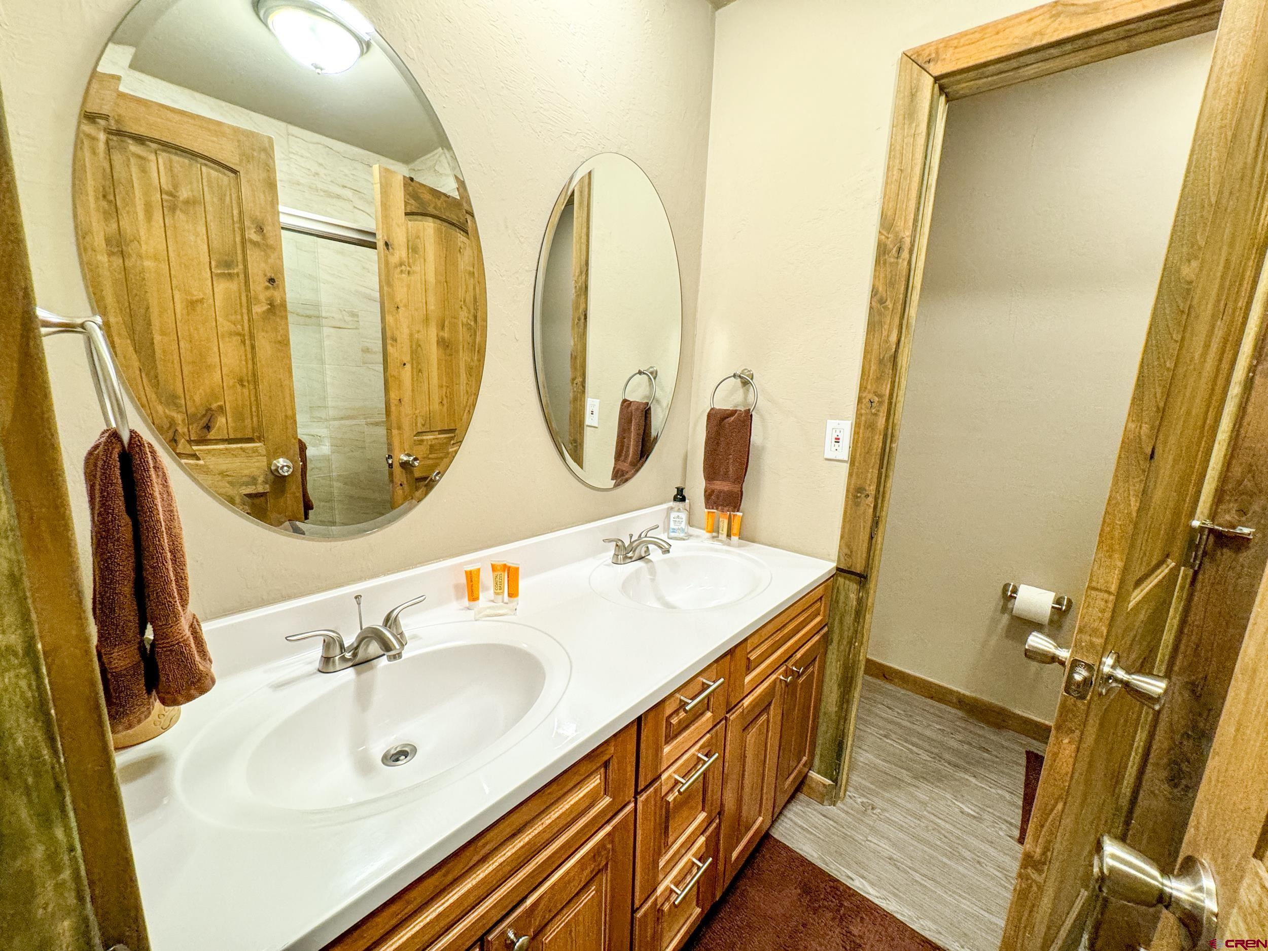 100 Teocalli Road, Unit 2 Crested Butte, CO 81224 - Photo 19 of 37 a bathroom with a double vanity sink and a mirror