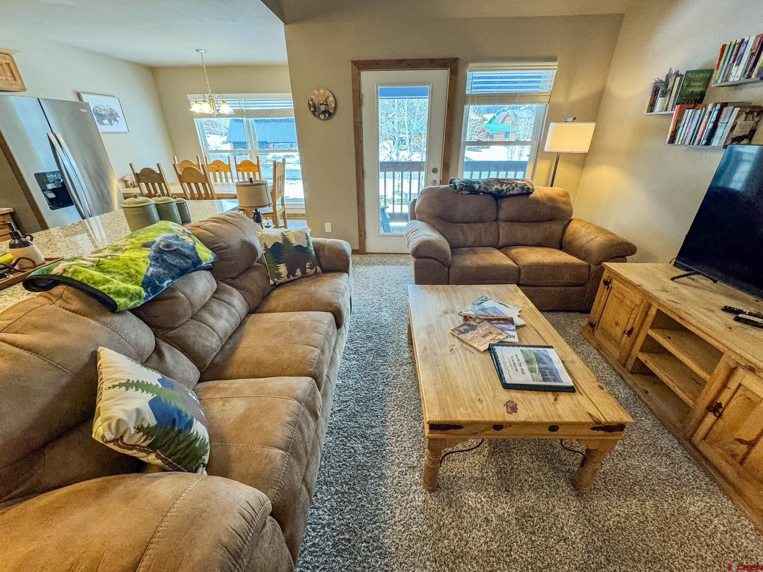 100 Teocalli Road, Unit 2 Crested Butte, CO 81224 - Photo 9 of 37 a living room with furniture and a flat screen tv
