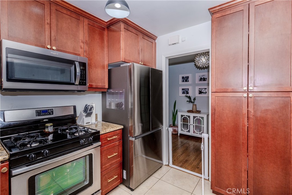 7734 Sycamore Avenue Riverside, CA 92504 - Photo 16 of 47 a kitchen with stainless steel appliances granite countertop a refrigerator and a stove top oven