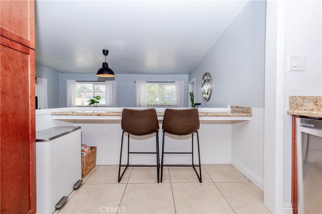 7734 Sycamore Avenue Riverside, CA 92504 - Photo 18 of 47 a kitchen with stainless steel appliances a sink cabinets and a window