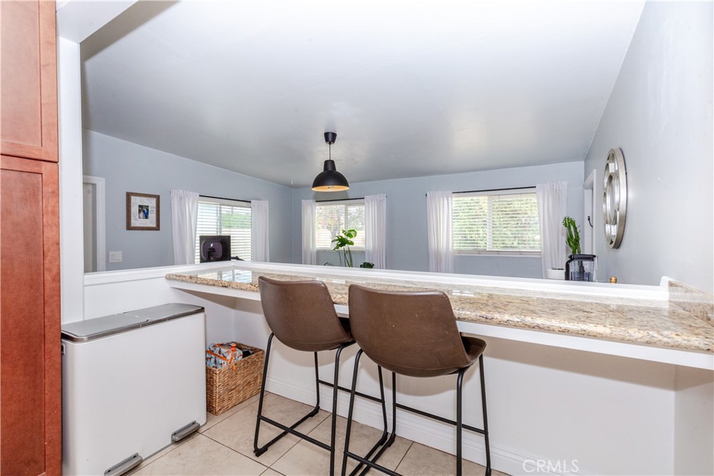 7734 Sycamore Avenue Riverside, CA 92504 - Photo 19 of 47 a view of kitchen island dining table and chairs