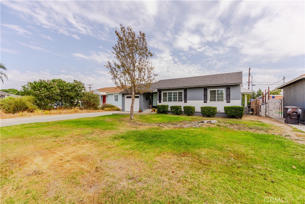 7734 Sycamore Avenue Riverside, CA 92504 - Photo 2 of 47 a front view of house with yard and green space