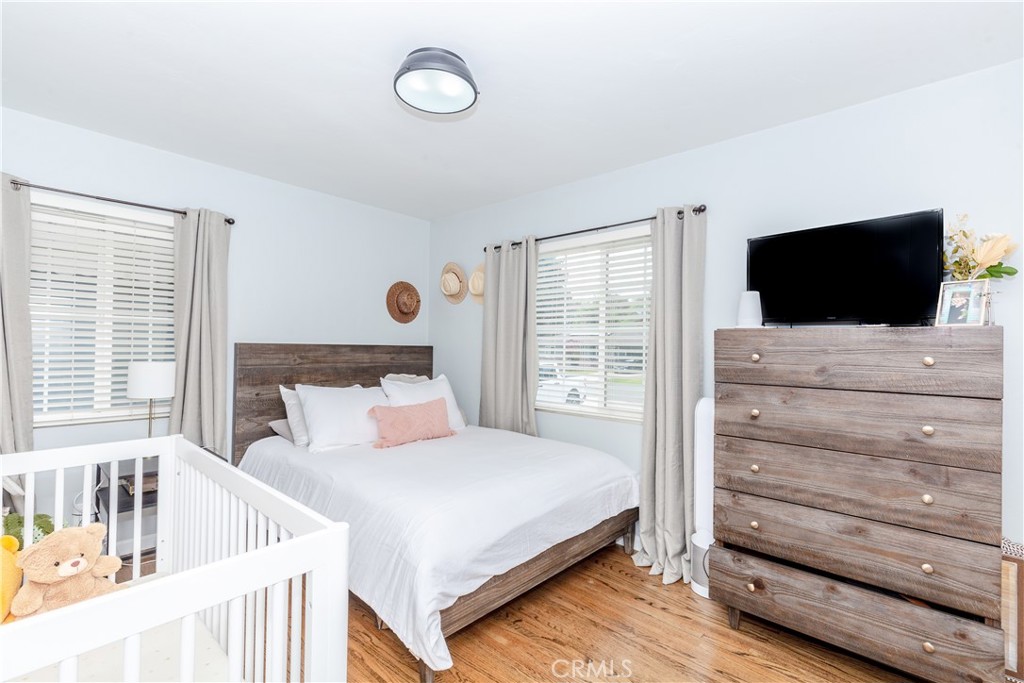 7734 Sycamore Avenue Riverside, CA 92504 - Photo 27 of 47 a bedroom with a bed and a flat screen tv