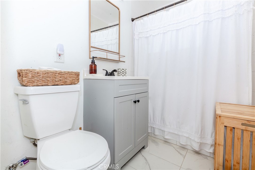 7734 Sycamore Avenue Riverside, CA 92504 - Photo 29 of 47 a bathroom with a sink a toilet and shower
