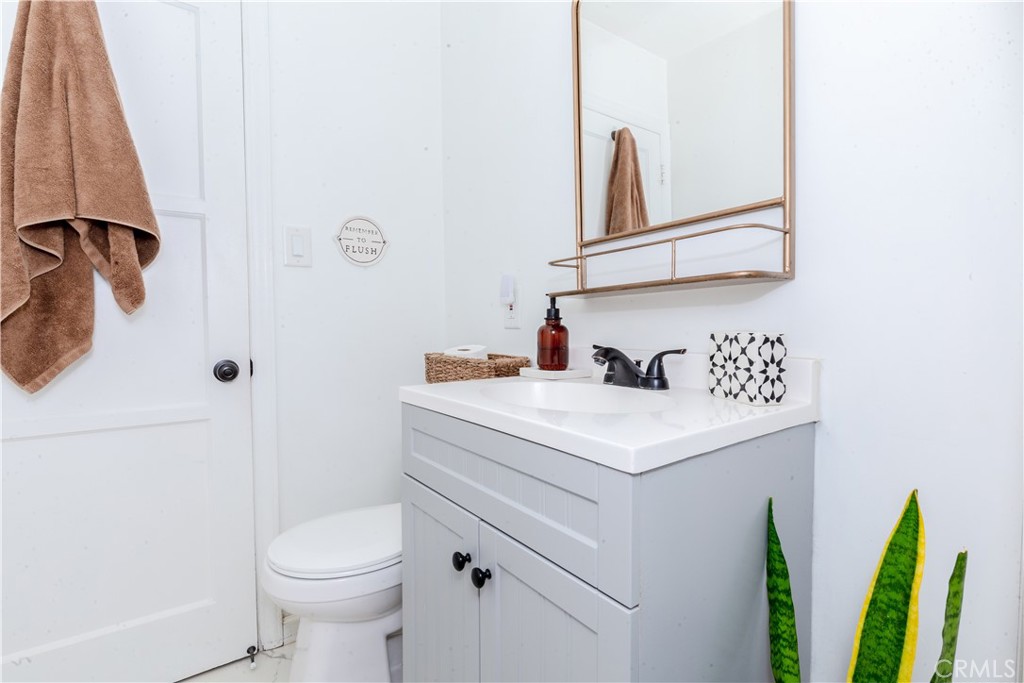 7734 Sycamore Avenue Riverside, CA 92504 - Photo 30 of 47 a bathroom with a sink vanity and toilet