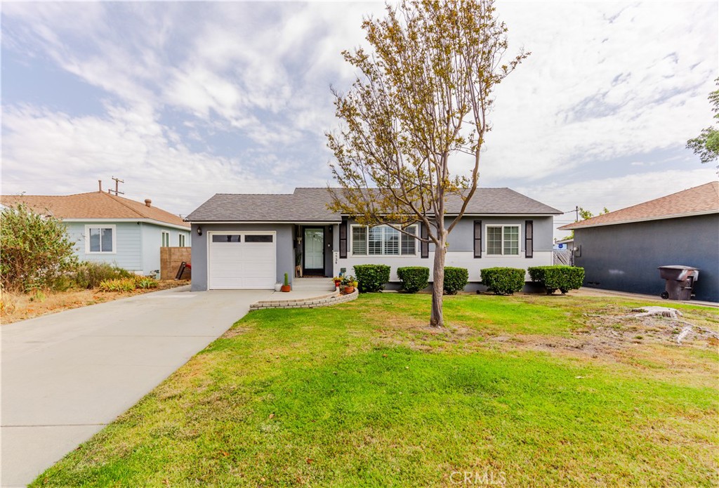 7734 Sycamore Avenue Riverside, CA 92504 - Photo 3 of 47 a front view of a house with a yard
