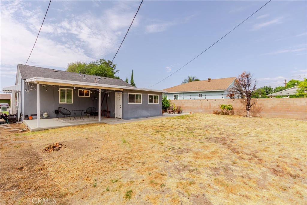 7734 Sycamore Avenue Riverside, CA 92504 - Photo 39 of 47 a front view of a house with a yard and potted plants