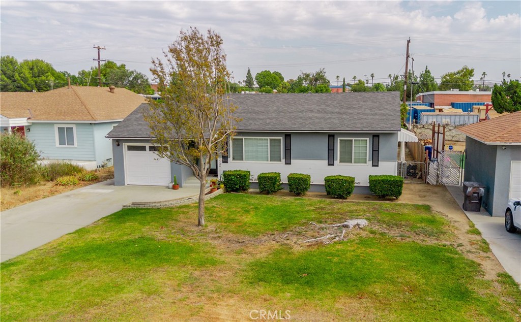 7734 Sycamore Avenue Riverside, CA 92504 - Photo 6 of 47 a front view of a house with a yard