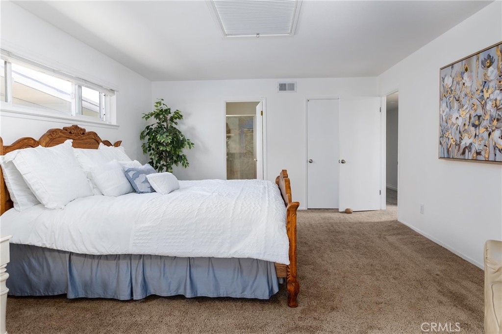 101 Java Street Morro Bay, CA 93442 - Photo 11 of 29 a bed sitting in a bedroom next to a window