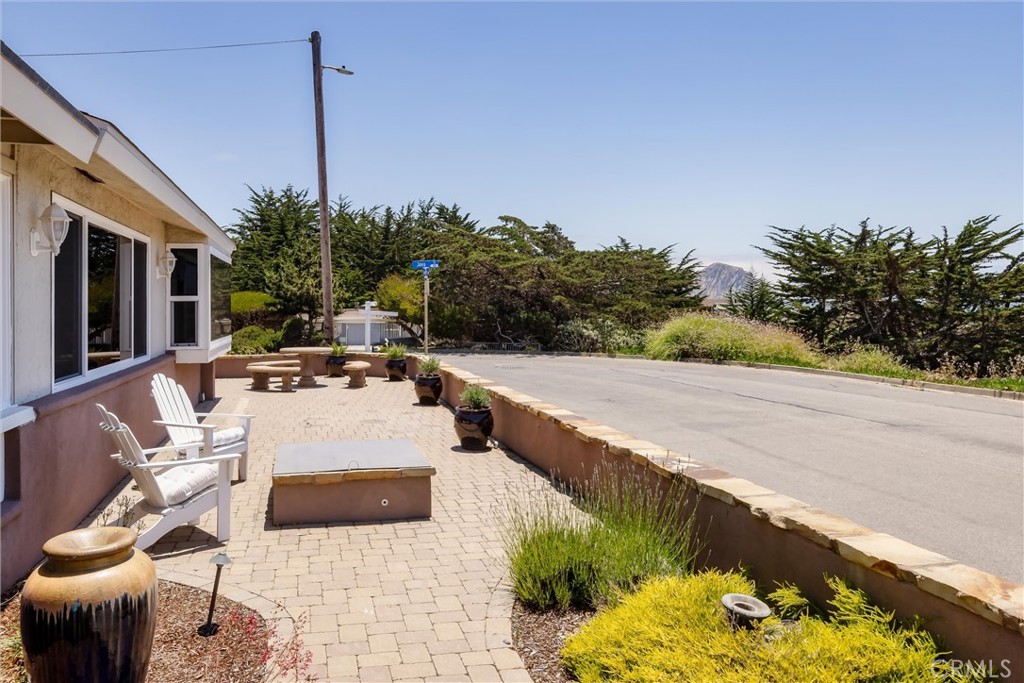 101 Java Street Morro Bay, CA 93442 - Photo 19 of 29 a view of a patio with couches and table and chairs with wooden fence