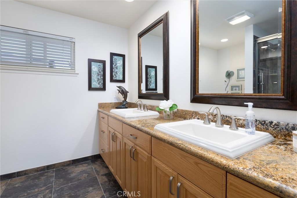 101 Java Street Morro Bay, CA 93442 - Photo 24 of 29 a bathroom with a granite countertop sink and a mirror