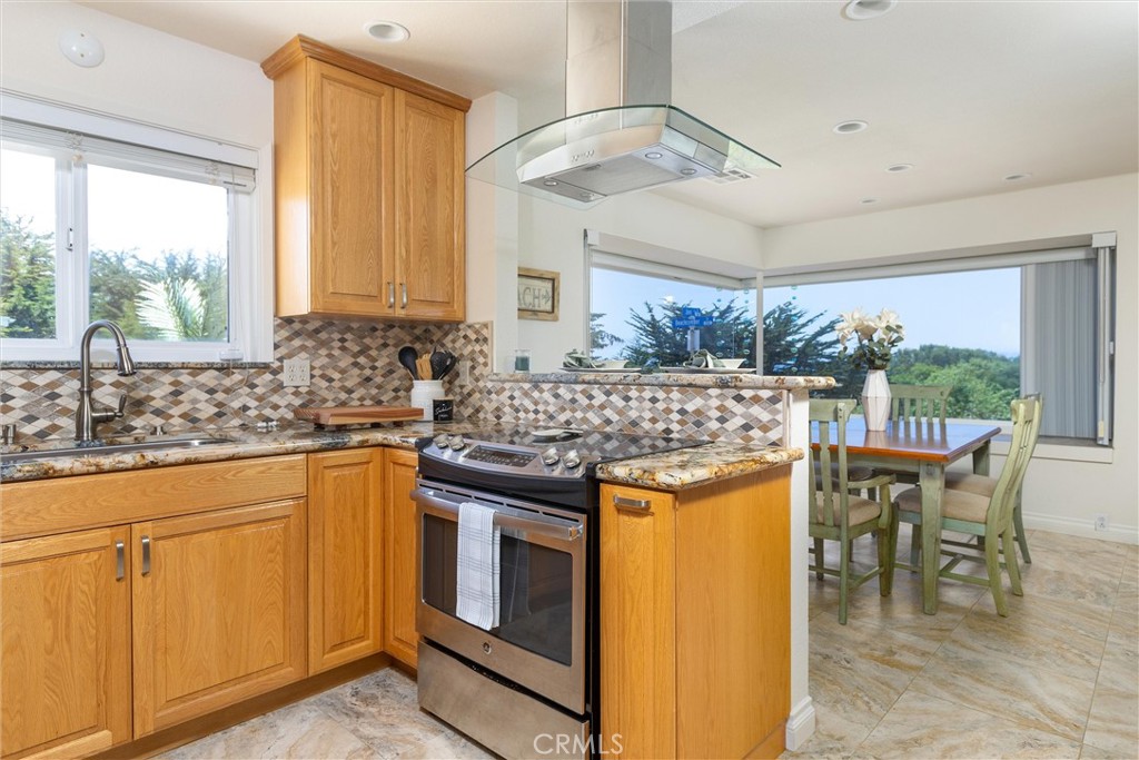 101 Java Street Morro Bay, CA 93442 - Photo 28 of 29 a kitchen with stainless steel appliances granite countertop a stove a sink and a refrigerator