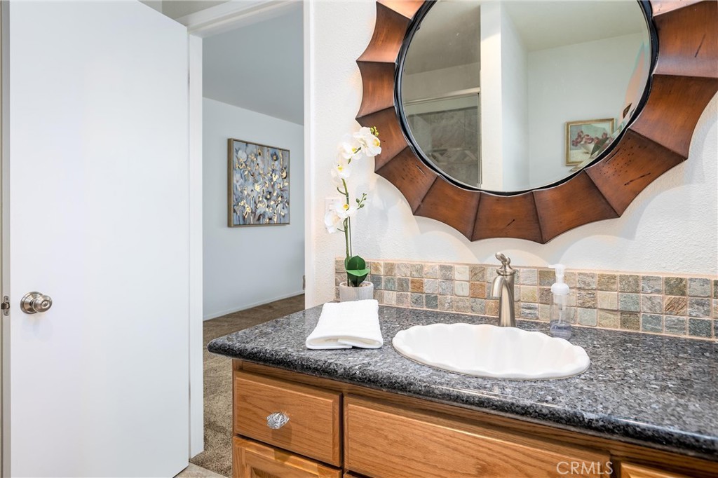 101 Java Street Morro Bay, CA 93442 - Photo 10 of 29 a bathroom with a granite countertop sink and a mirror