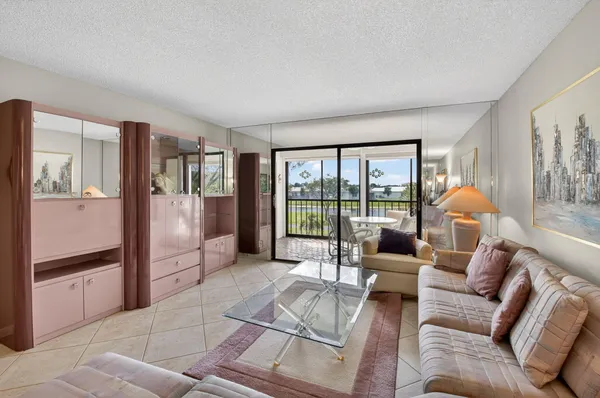 a living room with furniture and a floor to ceiling window