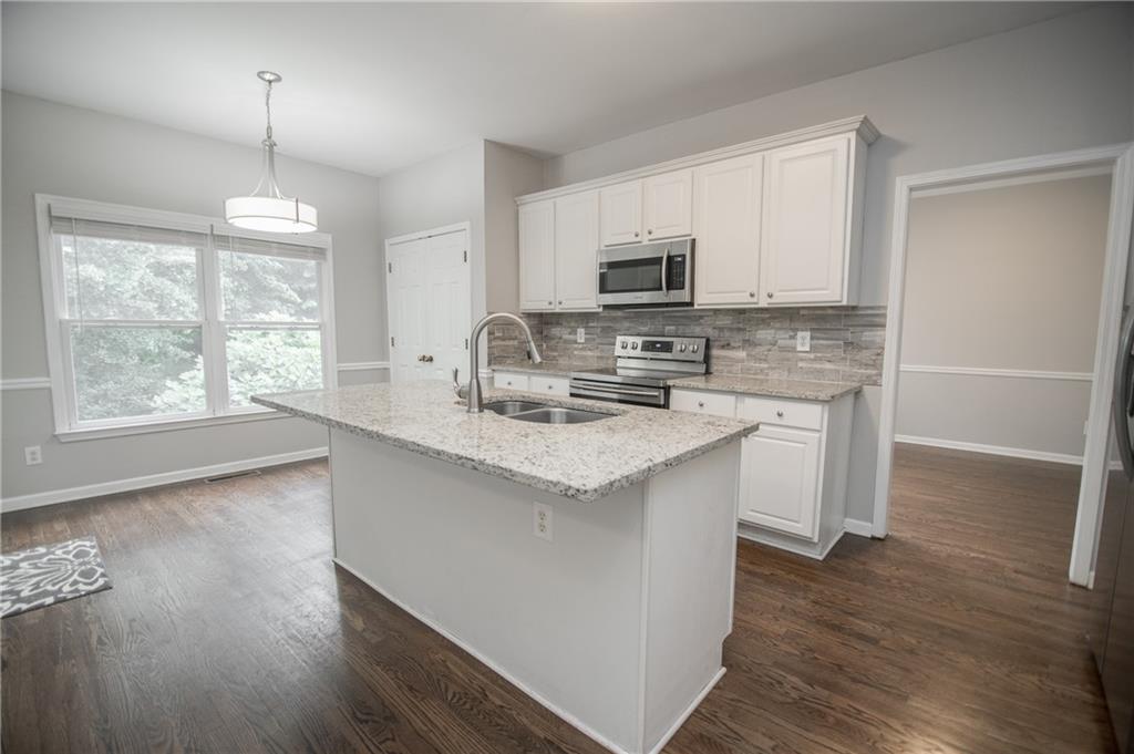 755 Sheridan Ridge Court Alpharetta, GA 30022 - Photo 11 of 57 a kitchen with stainless steel appliances granite countertop a sink stove and microwave