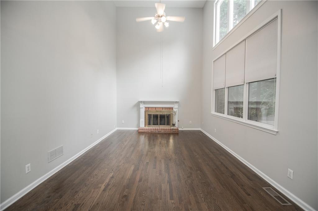 755 Sheridan Ridge Court Alpharetta, GA 30022 - Photo 15 of 57 an empty room with wooden floor and windows