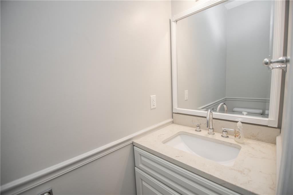 755 Sheridan Ridge Court Alpharetta, GA 30022 - Photo 22 of 57 a bathroom with a sink and a mirror
