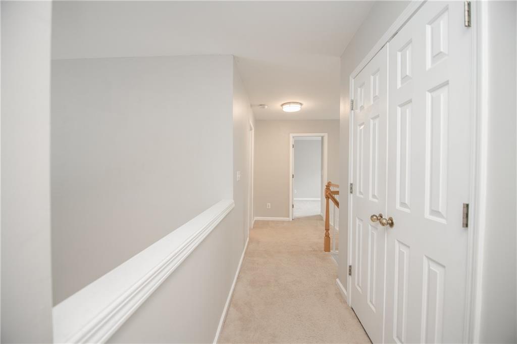 755 Sheridan Ridge Court Alpharetta, GA 30022 - Photo 25 of 57 a view of a hallway with wooden floor and closet area