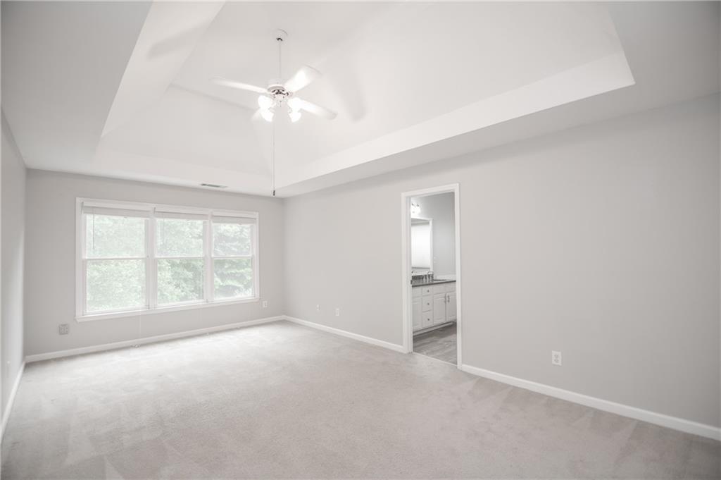 755 Sheridan Ridge Court Alpharetta, GA 30022 - Photo 27 of 57 an empty room with windows and chandelier fan