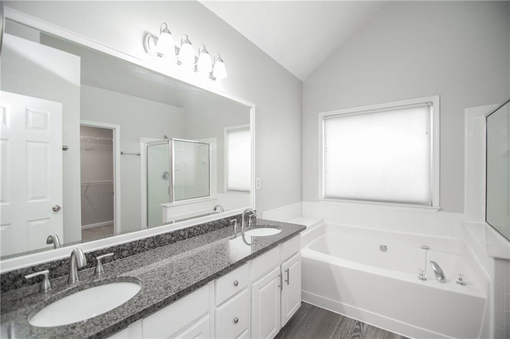 755 Sheridan Ridge Court Alpharetta, GA 30022 - Photo 32 of 57 a bathroom with a tub double sink and mirror