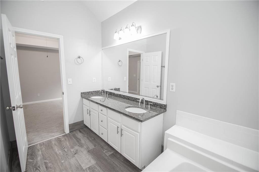 755 Sheridan Ridge Court Alpharetta, GA 30022 - Photo 33 of 57 a bathroom with a granite countertop sink and a mirror