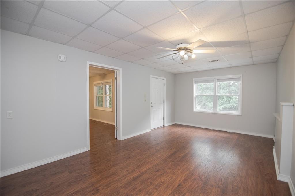 755 Sheridan Ridge Court Alpharetta, GA 30022 - Photo 37 of 57 an empty room with wooden floor chandelier fan and windows