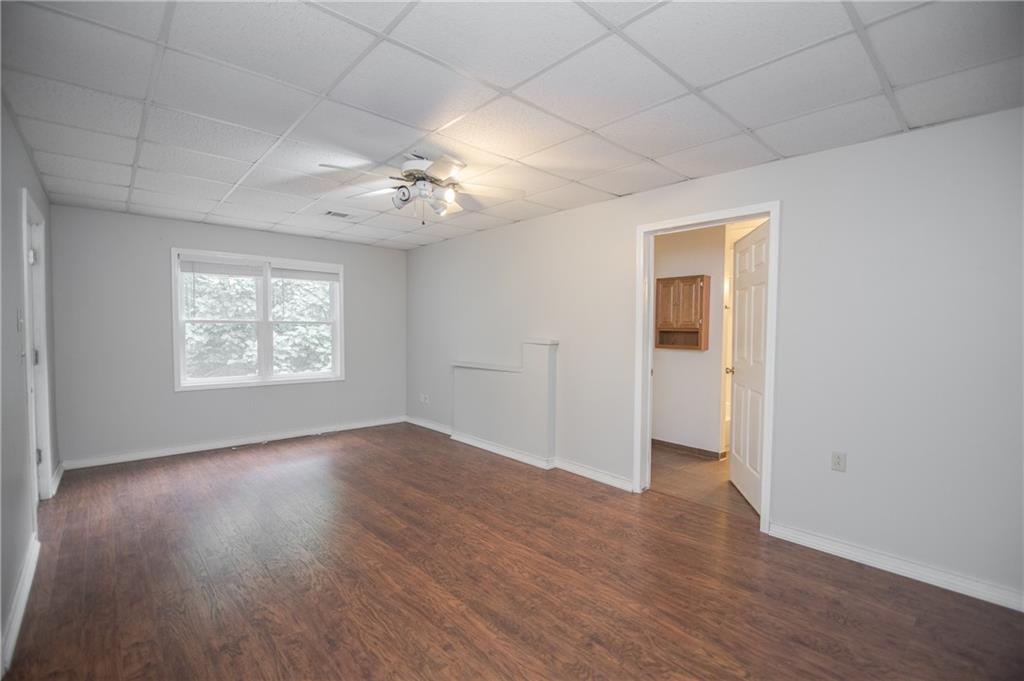 755 Sheridan Ridge Court Alpharetta, GA 30022 - Photo 38 of 57 an empty room with wooden floor chandelier fan and windows