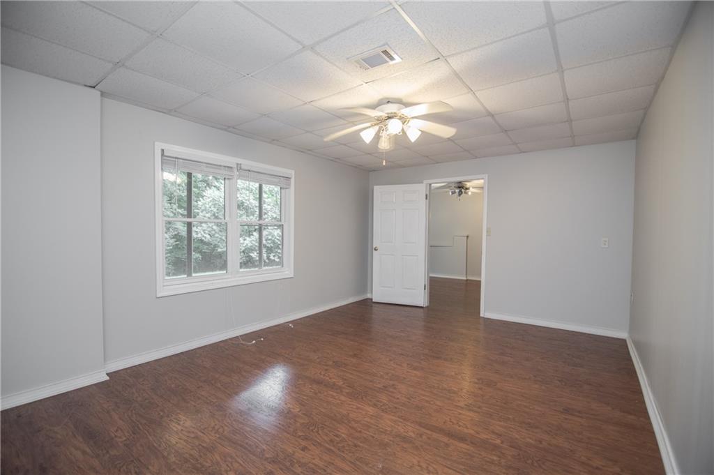 755 Sheridan Ridge Court Alpharetta, GA 30022 - Photo 42 of 57 an empty room with wooden floor and windows