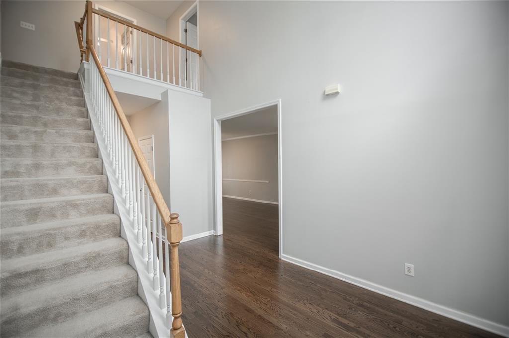 755 Sheridan Ridge Court Alpharetta, GA 30022 - Photo 5 of 57 wooden floor in an empty room with stairs