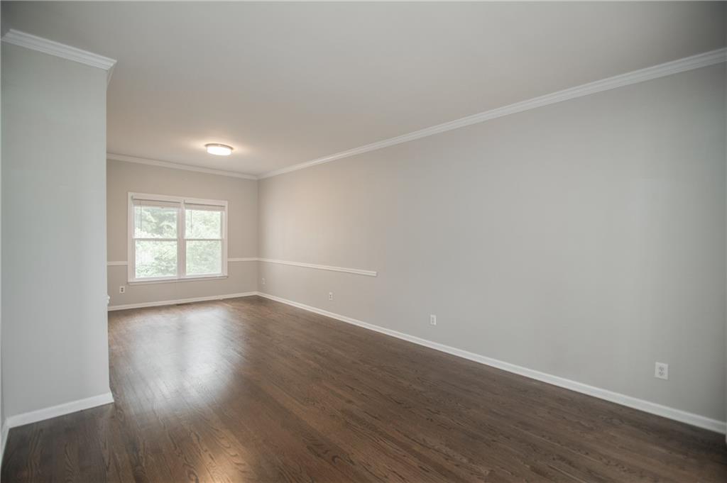 755 Sheridan Ridge Court Alpharetta, GA 30022 - Photo 6 of 57 a view of an empty room with wooden floor and a window