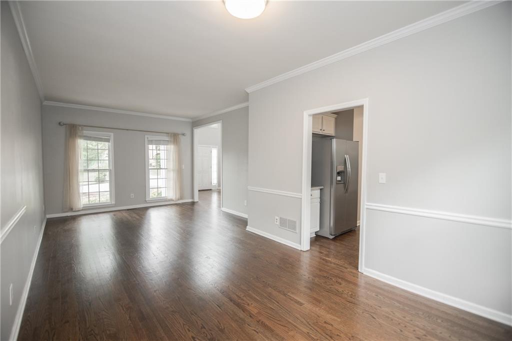 755 Sheridan Ridge Court Alpharetta, GA 30022 - Photo 9 of 57 an empty room with wooden floor and windows