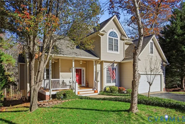 a front view of a house with garden and plants