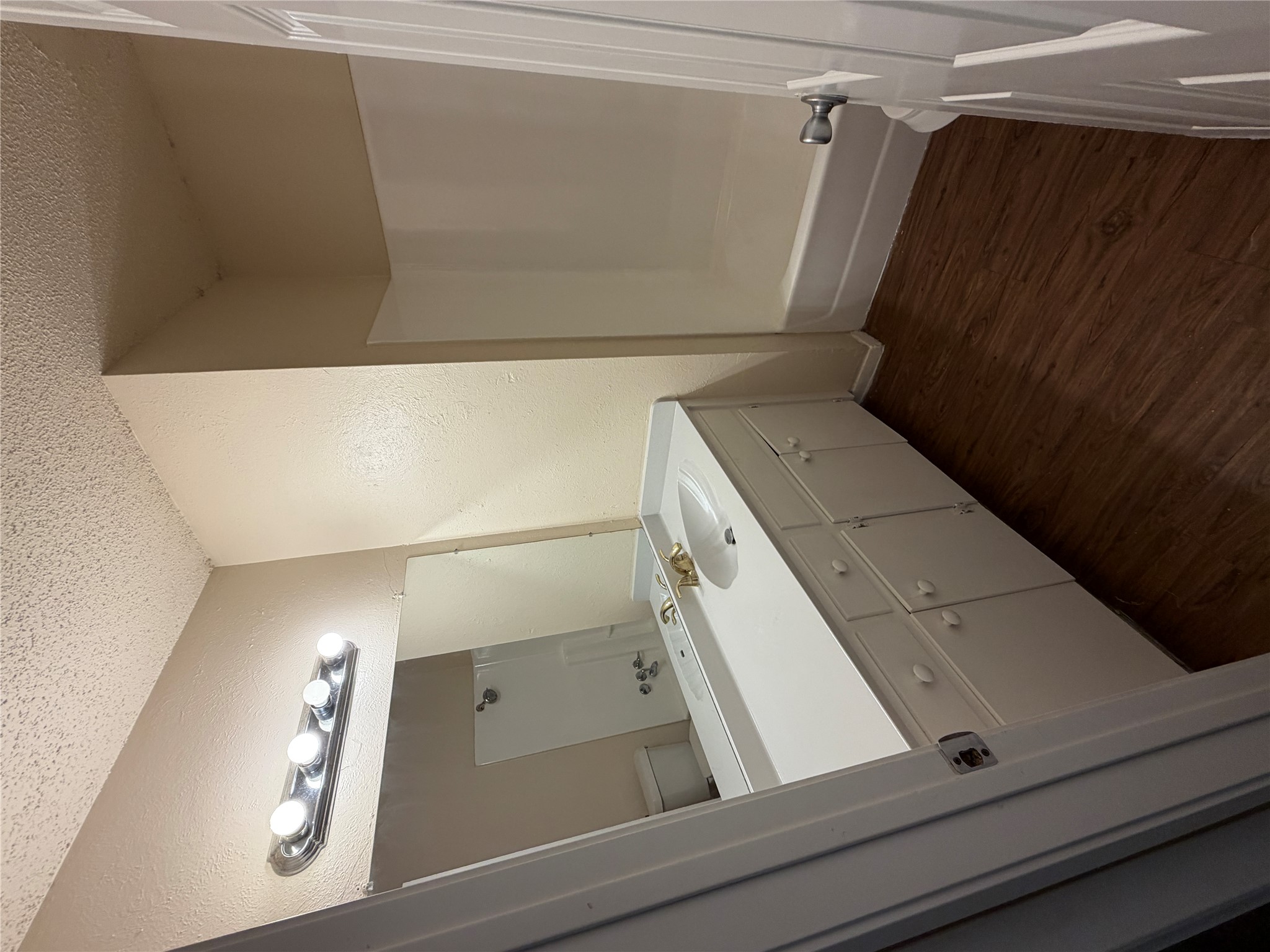 4702 Rocking Chair Road Austin, TX 78744 - Photo 11 of 28 Full bathroom with dark wood-style flooring, vanity, a textured ceiling, a textured wall, and bathtub / shower combination