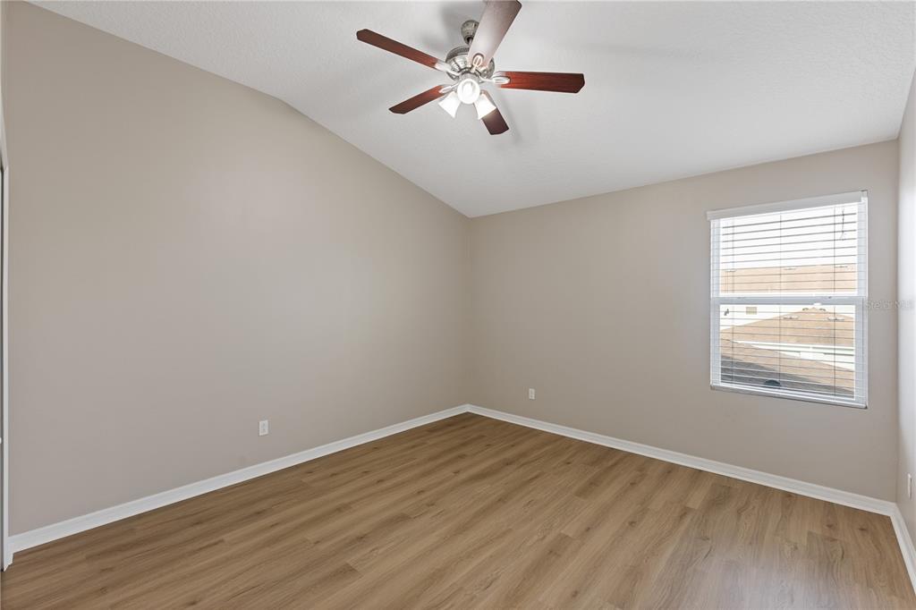 506 Rainbow Springs Loop Groveland, FL 34736 - Photo 15 of 30 an empty room with wooden floor and windows