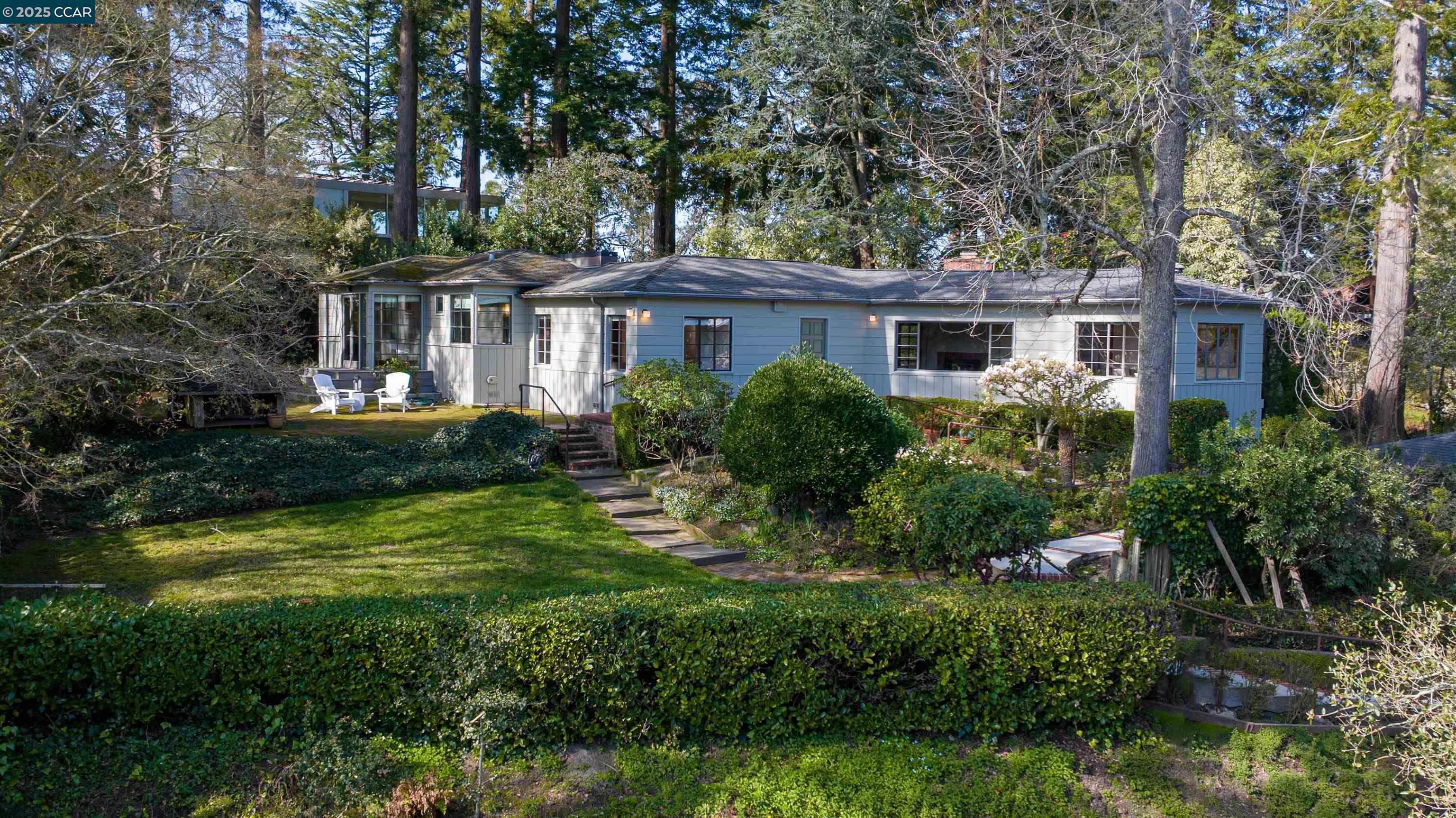 a view of a house with a yard and potted plants