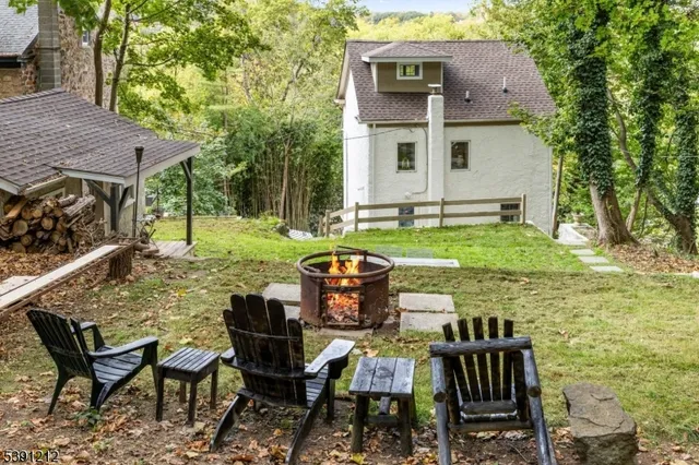 a view of a chairs and table in backyard