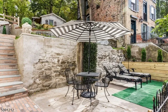 a view of a patio with table and chairs and potted plants