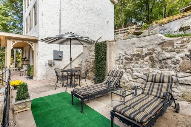 a view of a patio with a table and chairs