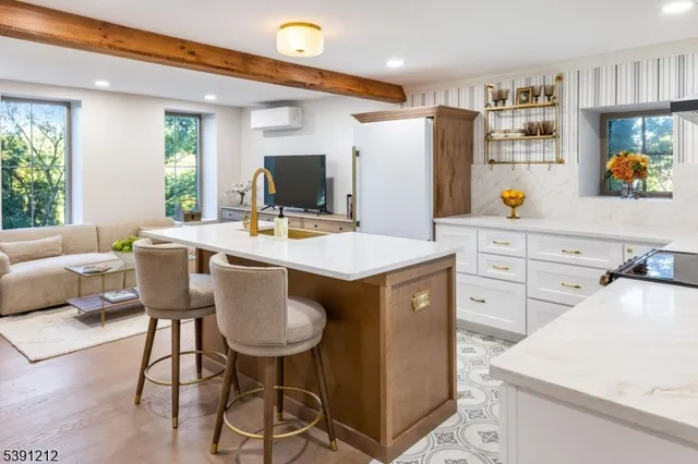 a kitchen with stainless steel appliances a sink a table and chairs