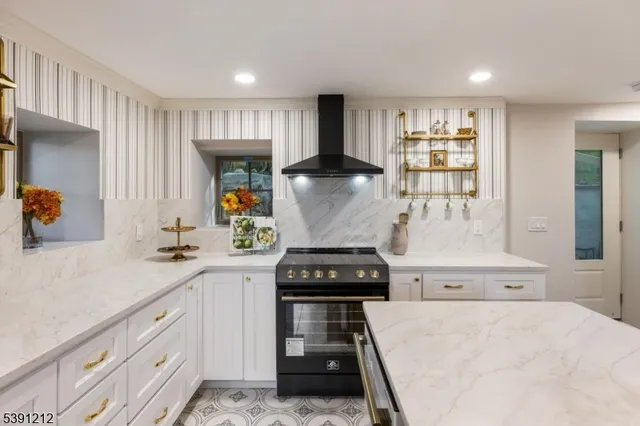 a kitchen with a stove and white cabinets