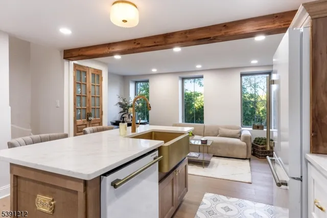 a living room with kitchen island furniture and a large window