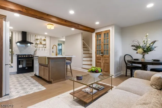 a living room with furniture a dining table and kitchen view
