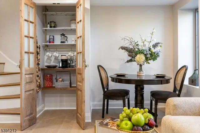 a dining room with furniture and a potted plant
