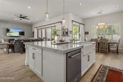 a kitchen with stainless steel appliances granite countertop sink stove top oven and cabinets